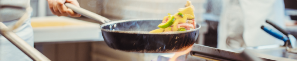 Kitchen staff preparing food in a professional F&B kitchen, highlighting operational efficiency and workflow challenges